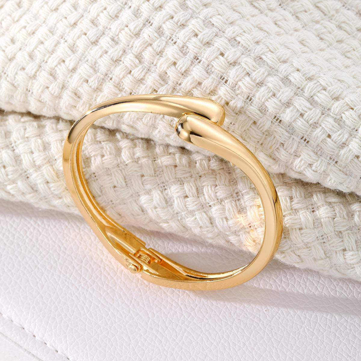 Polished Gold-Tone Bangle Bracelet with Elegant Curve