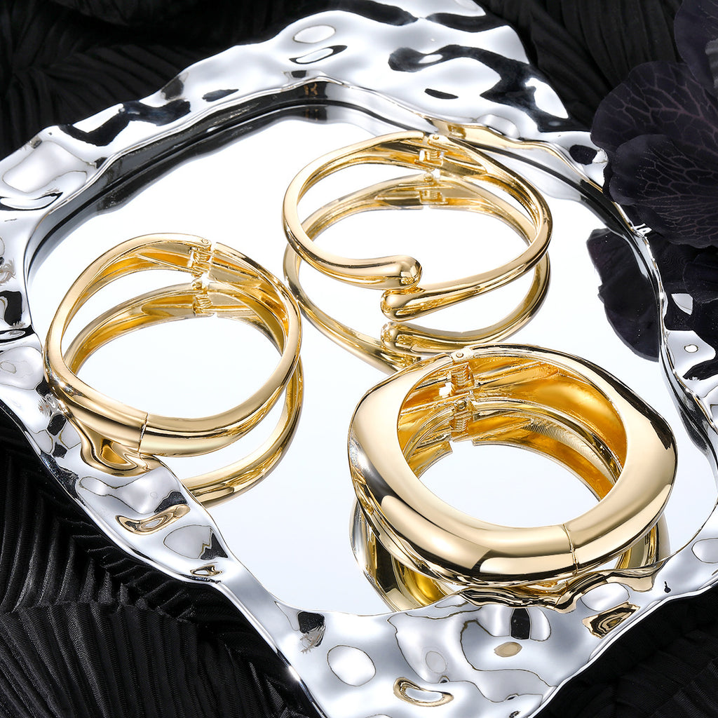 Polished Gold-Tone Bangle Bracelet with Elegant Curve