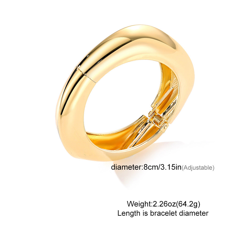 Polished Gold-Tone Bangle Bracelet with Elegant Curve