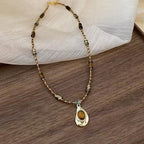 Vintage Gold Beaded Necklace with Teardrop Pendant