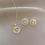 Gold Crystal Sun Pendant Necklace with Pearl Center