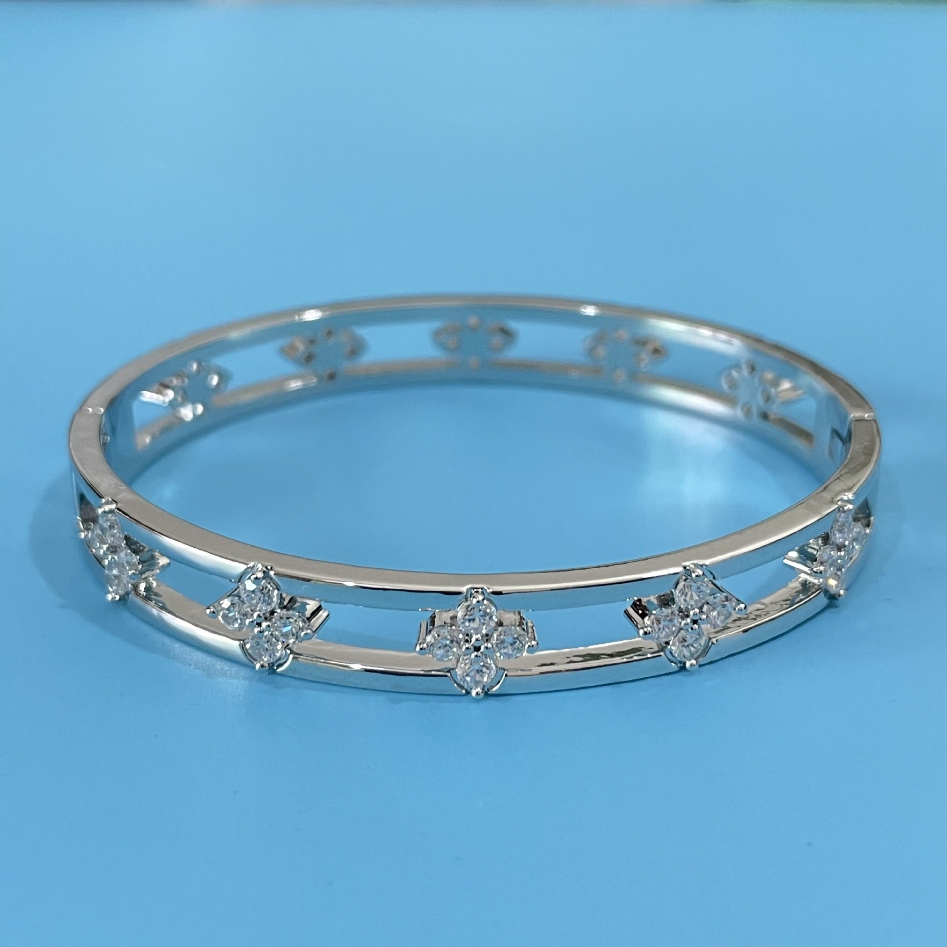 Floral Detail Bangle Bracelet with Elegant Openwork Design